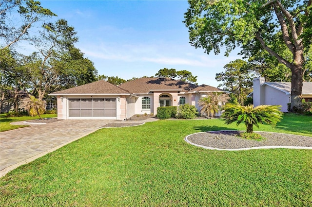 5296 Slater Rd, Spring Hill, FL 34608 - view of front of property with an attached garage, driveway, a front yard, and stucco siding