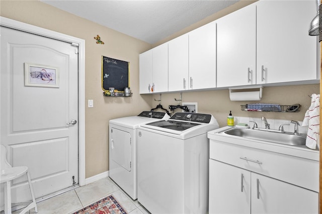 5296 Slater Rd, Spring Hill, FL 34608 - washroom with separate washer and dryer, cabinet space, and light tile patterned floors