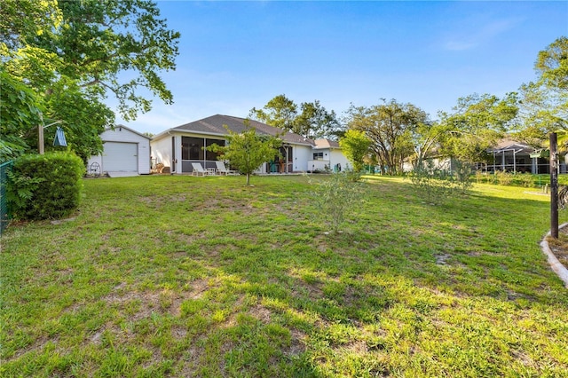 5296 Slater Rd, Spring Hill, FL 34608 - view of green lawn featuring a sunroom, an outdoor structure, and a garage