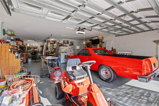 5296 Slater Rd, Spring Hill, FL 34608 - garage with a garage door opener and freestanding refrigerator