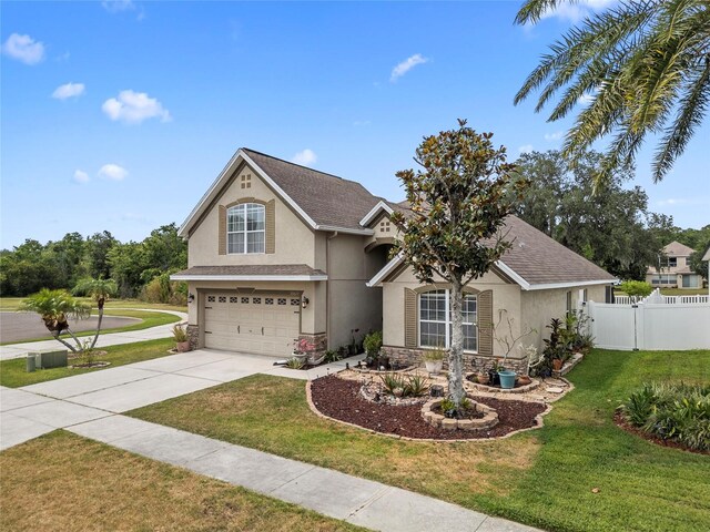 35819 Diamond Head Ct, Zephyrhills, FL 33541 - traditional-style house featuring stucco siding, a garage, driveway, stone siding, and roof with shingles
