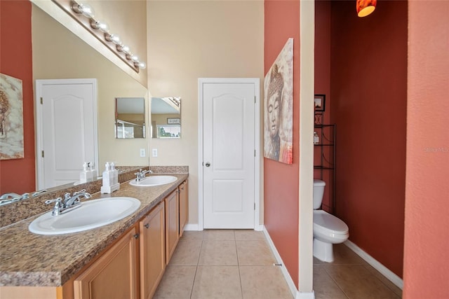 35819 Diamond Head Ct, Zephyrhills, FL 33541 - bathroom with tile patterned flooring, toilet, baseboards, and double vanity