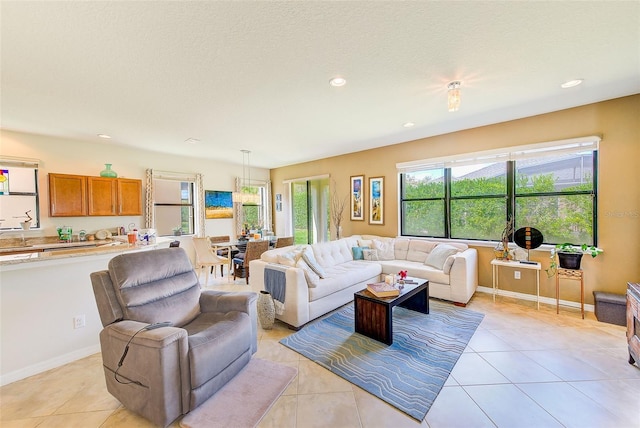 living area with light tile patterned floors, recessed lighting, and baseboards