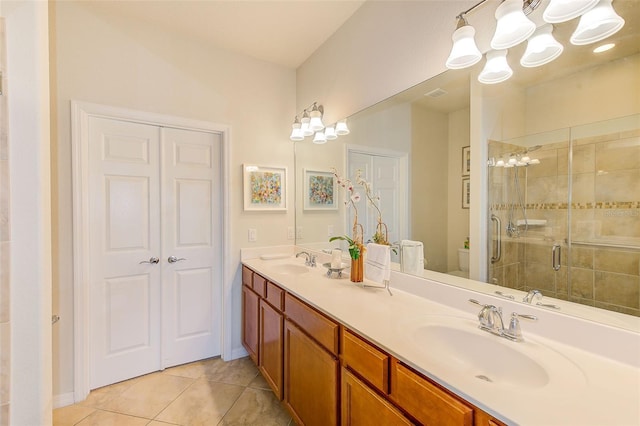 full bathroom with toilet, a chandelier, a shower stall, tile patterned flooring, and double vanity
