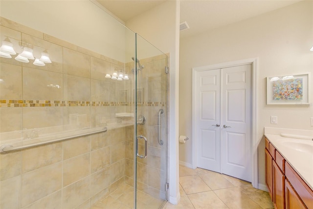 bathroom featuring a stall shower, vanity, and tile patterned flooring