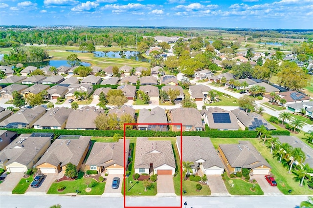aerial perspective of suburban area with a large body of water and property boundaries highlighted