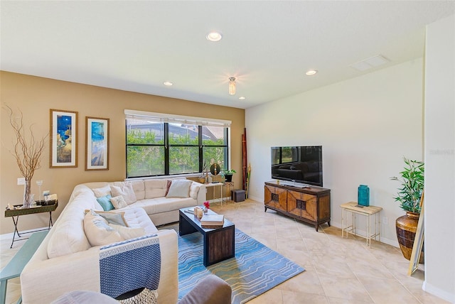 living room featuring recessed lighting, light tile patterned floors, and baseboards