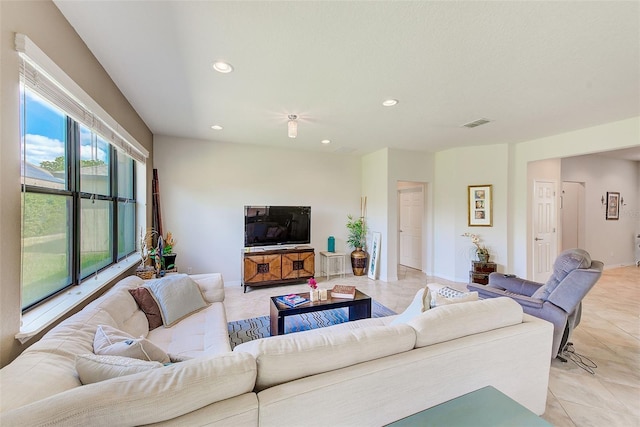 living area featuring recessed lighting, light tile patterned floors, and baseboards