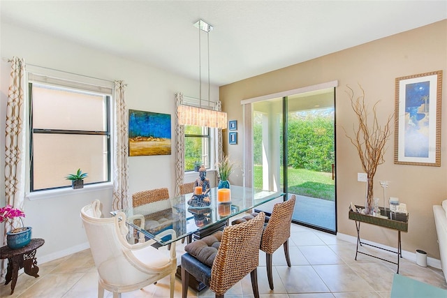 dining room featuring light tile patterned floors and baseboards