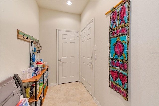 entryway featuring light tile patterned flooring, recessed lighting, and baseboards