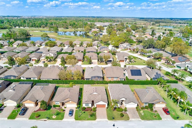 aerial view of residential area featuring a large body of water
