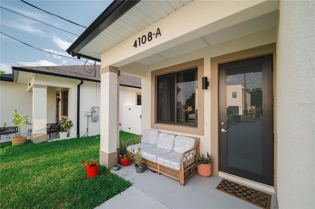 4108 N Thatcher, Tampa, FL 33614 - property entrance with stucco siding and a yard