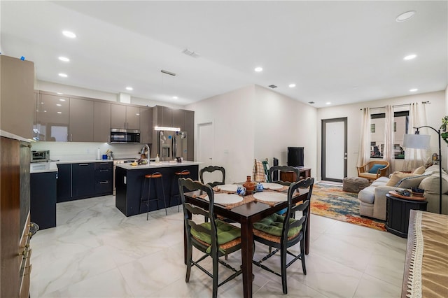 4108 N Thatcher, Tampa, FL 33614 - dining room featuring recessed lighting and light marble finish flooring