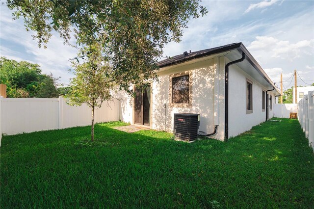 4108 N Thatcher, Tampa, FL 33614 - rear view of house featuring cooling unit and stucco siding