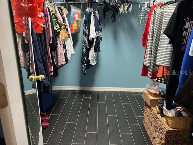 spacious closet with wood tiled floors