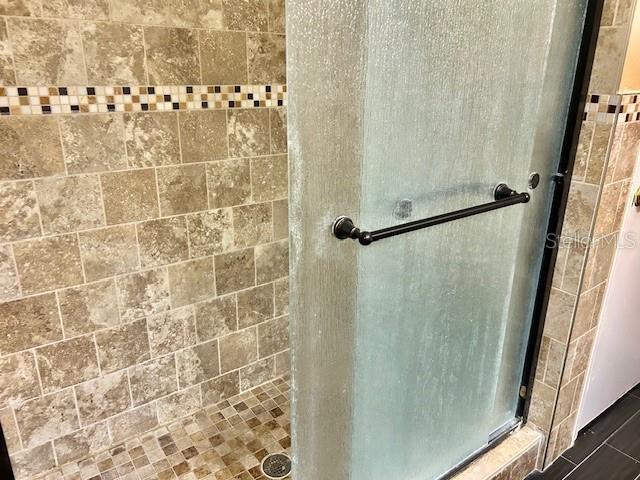 full bathroom featuring a stall shower