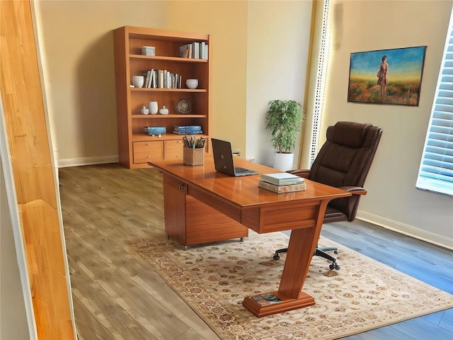 office space with wood finished floors and baseboards