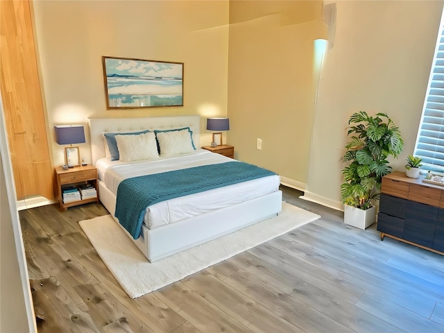 bedroom featuring wood finished floors and baseboards