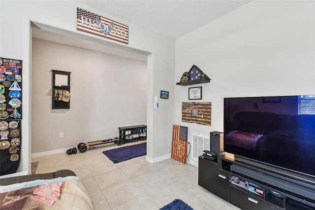 interior space featuring light tile patterned flooring, baseboards, and visible vents