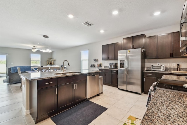 kitchen with a healthy amount of sunlight, stainless steel appliances, visible vents, and a sink
