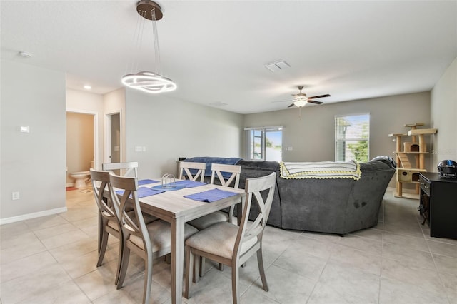 dining space featuring light tile patterned floors, baseboards, visible vents, and ceiling fan