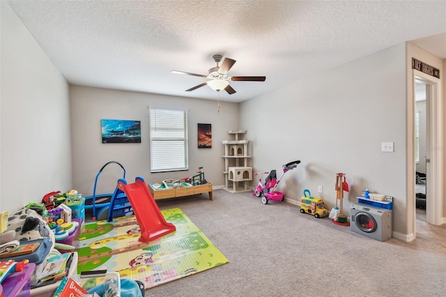 game room with carpet flooring, a textured ceiling, baseboards, and a ceiling fan