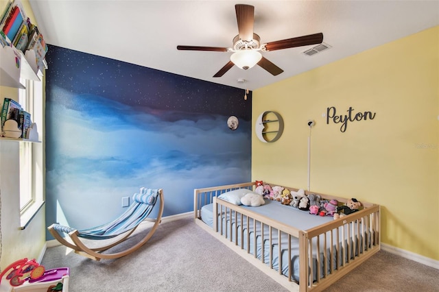 bedroom with baseboards, carpet flooring, visible vents, and a ceiling fan