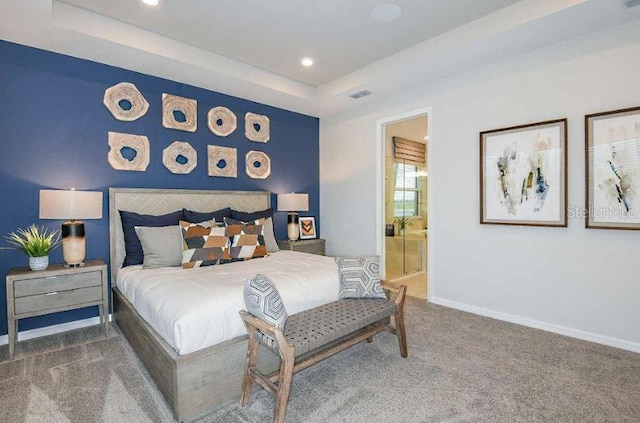 carpeted bedroom with connected bathroom, a tray ceiling, visible vents, baseboards, and recessed lighting
