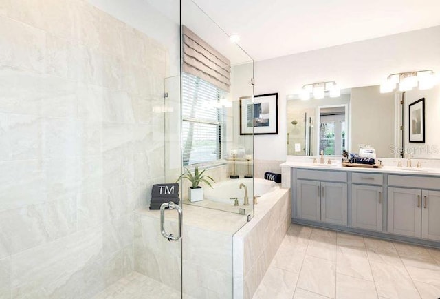 full bathroom with a sink, double vanity, a shower stall, and a bath