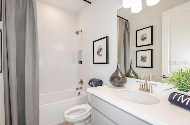 full bath with toilet, shower / tub combo with curtain, and vanity