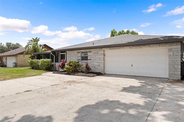 916 Shangri La Dr, Seffner, FL 33584 - single story home with driveway, an attached garage, and stone siding