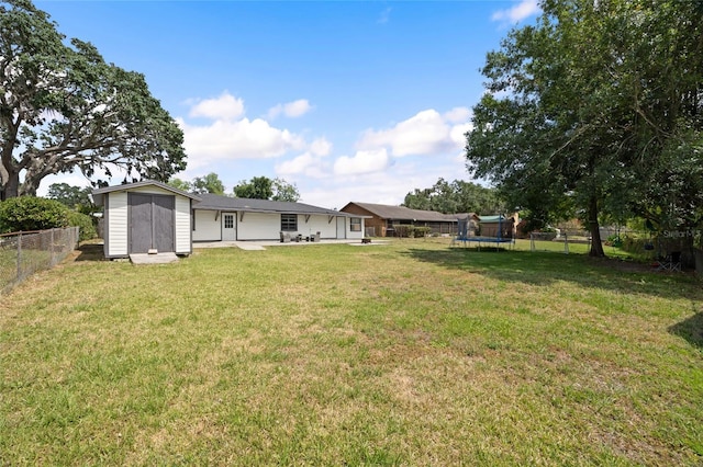 916 Shangri La Dr, Seffner, FL 33584 - view of yard featuring a trampoline, a storage unit, an outbuilding, and a patio area