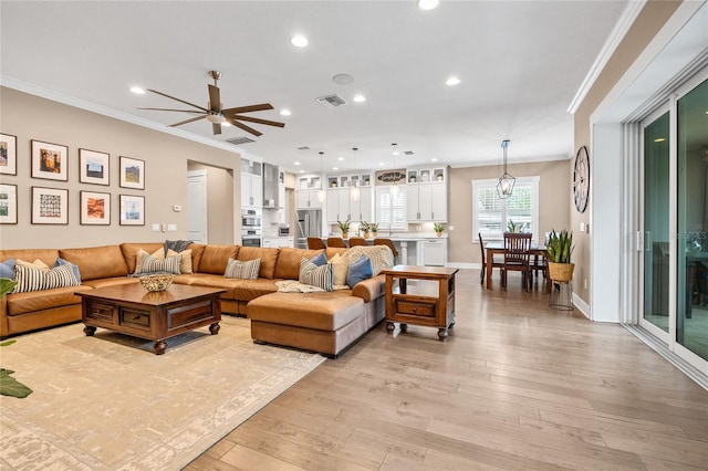 3611 W Royal Palm Cir, Tampa, FL 33629 - living room featuring light wood-style flooring, crown molding, recessed lighting, a ceiling fan, and baseboards