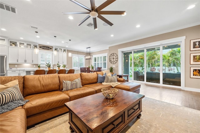 3611 W Royal Palm Cir, Tampa, FL 33629 - living area with recessed lighting, healthy amount of natural light, crown molding, ceiling fan, and light wood-type flooring