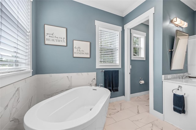 3611 W Royal Palm Cir, Tampa, FL 33629 - bathroom with marble look tiles, a soaking tub, ornamental molding, and vanity