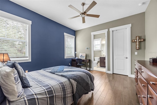 3611 W Royal Palm Cir, Tampa, FL 33629 - bedroom with dark wood finished floors, ensuite bathroom, a ceiling fan, and baseboards
