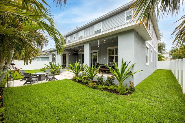3611 W Royal Palm Cir, Tampa, FL 33629 - rear view of house with stucco siding, a fire pit, and a patio area