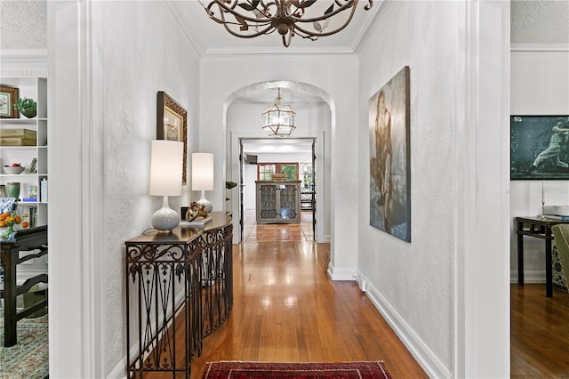 136 W Davis Blvd, Tampa, FL 33606 - corridor with a chandelier, a textured wall, arched walkways, wood finished floors, and ornamental molding
