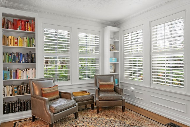 136 W Davis Blvd, Tampa, FL 33606 - living area with crown molding, wood finished floors, and built in shelves