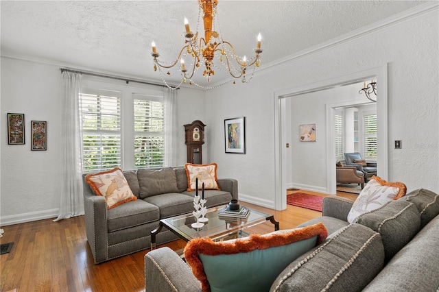 136 W Davis Blvd, Tampa, FL 33606 - living area featuring a chandelier, a textured ceiling, wood finished floors, ornamental molding, and baseboards