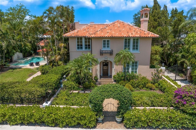 136 W Davis Blvd, Tampa, FL 33606 - mediterranean / spanish house with stucco siding, a tile roof, and a chimney
