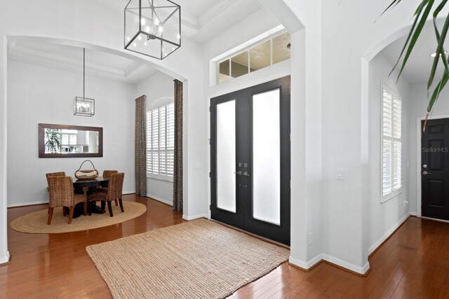 entryway with french doors, a chandelier, and healthy amount of natural light