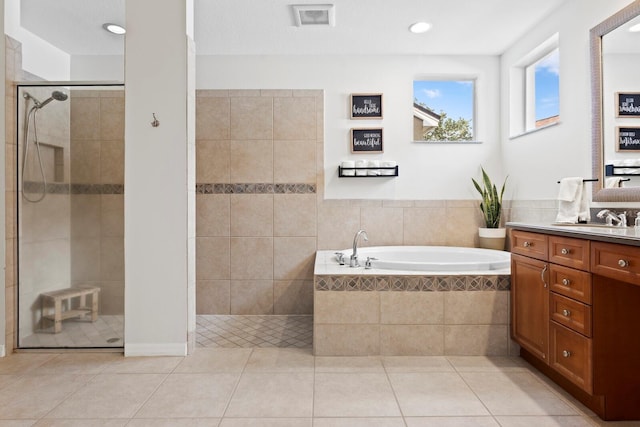 full bath with tiled shower, a bath, tile patterned floors, vanity, and recessed lighting