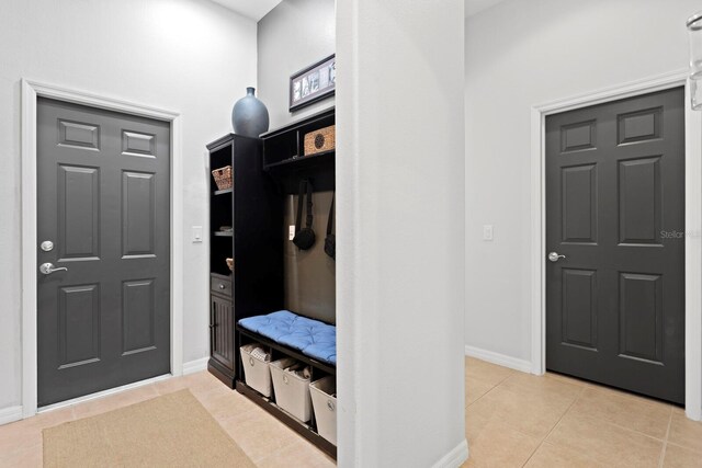 mudroom with light tile patterned floors and baseboards