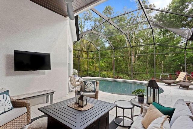 outdoor pool featuring an outdoor living space, a patio area, and a lanai
