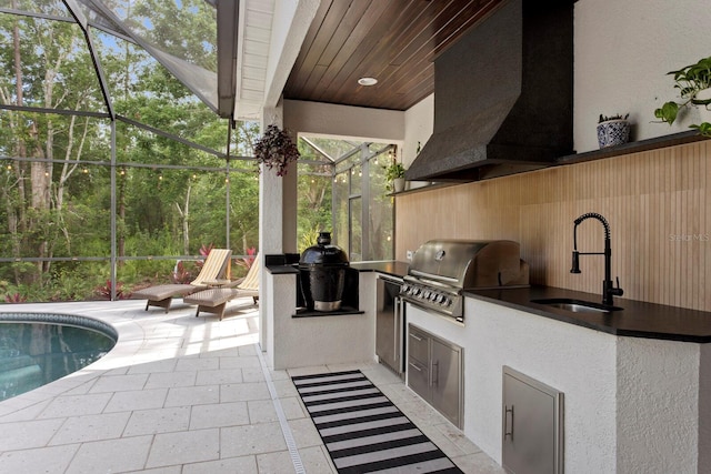 view of patio featuring a sink, area for grilling, a grill, glass enclosure, and an outdoor pool