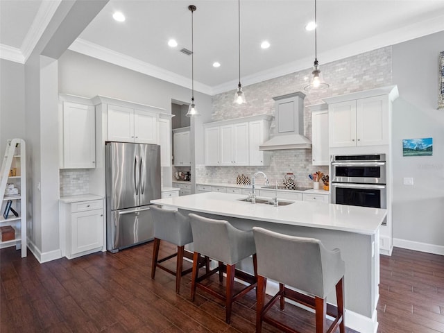 1104 Isobel Reserve Ln, Tampa, FL 33613 - kitchen featuring appliances with stainless steel finishes, a sink, light countertops, custom exhaust hood, and ornamental molding