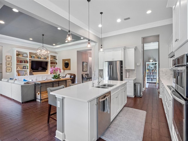 1104 Isobel Reserve Ln, Tampa, FL 33613 - kitchen featuring appliances with stainless steel finishes, a sink, light countertops, dark wood finished floors, and recessed lighting