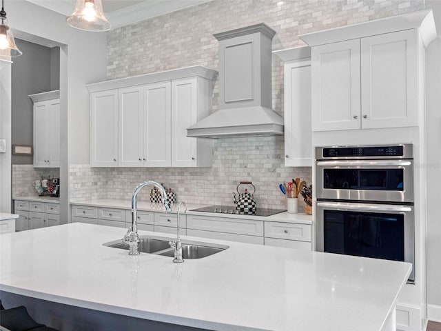 1104 Isobel Reserve Ln, Tampa, FL 33613 - kitchen featuring wall chimney range hood, a sink, black electric stovetop, stainless steel double oven, and light countertops