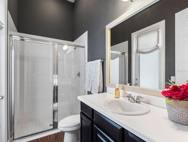 1104 Isobel Reserve Ln, Tampa, FL 33613 - bathroom with a shower stall, vanity, toilet, and wood finished floors
